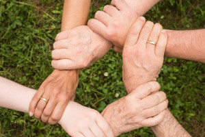 five hands held in a circle 