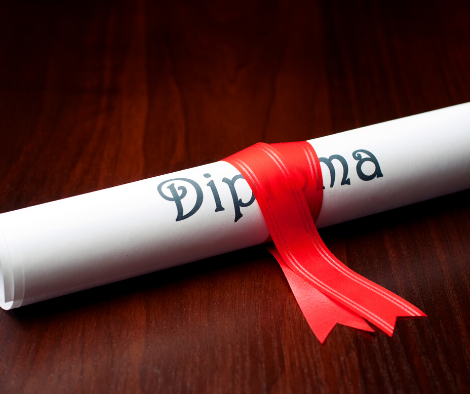 Photo of a rolled certificate with decorative ribbon on top