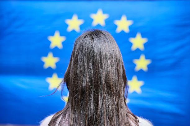 woman facing the european flag