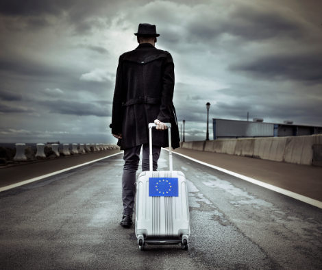 Man walking away with a suitcase with EU emblem